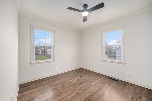 empty room featuring ceiling fan, ornamental molding, and dark wood-type flooring