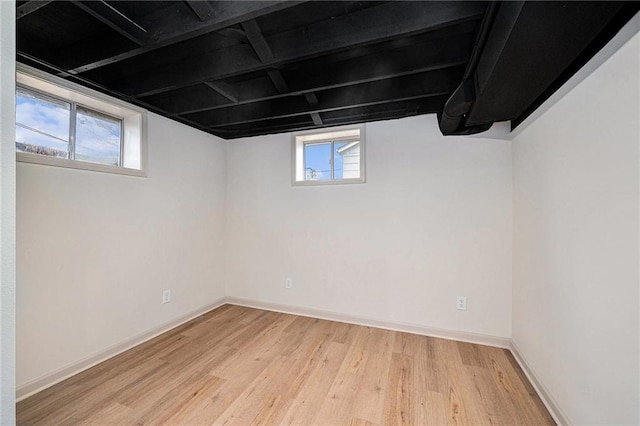 basement featuring plenty of natural light and light wood-type flooring