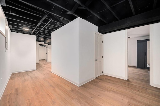 basement with light hardwood / wood-style floors