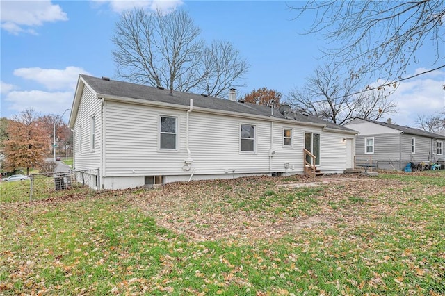 rear view of house with a yard