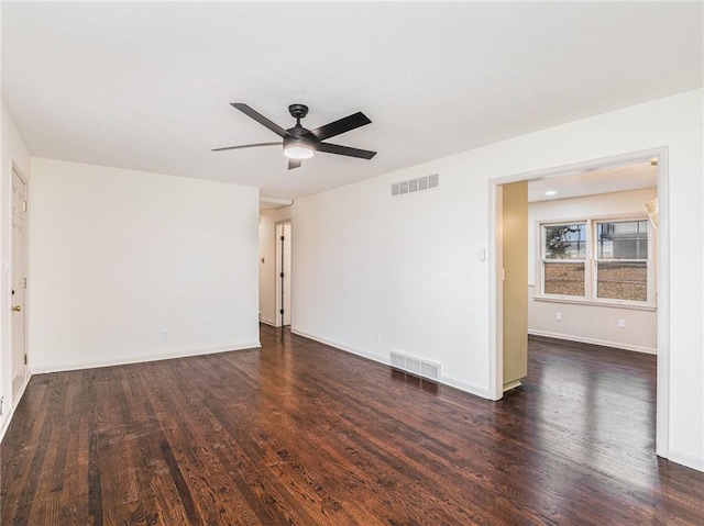 empty room featuring ceiling fan and dark wood-type flooring