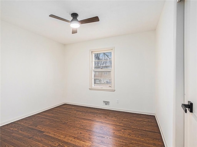 unfurnished room with ceiling fan and dark wood-type flooring