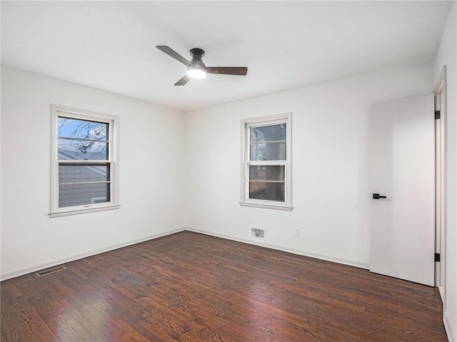 unfurnished room featuring ceiling fan and dark wood-type flooring