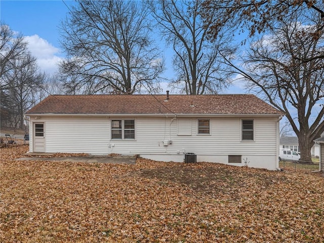 back of house with central AC unit