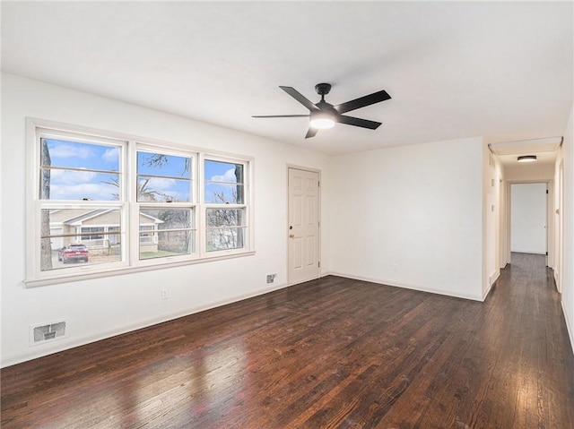 spare room featuring ceiling fan and dark wood-type flooring