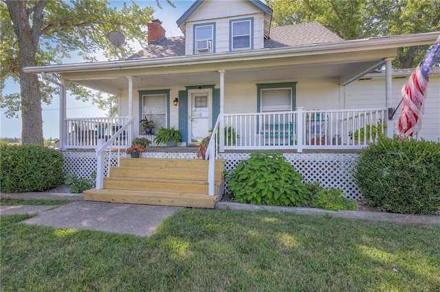 view of front of house with a porch and a front lawn