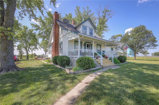 view of front facade with a front yard and a porch