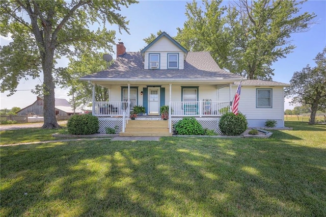 view of front of property featuring covered porch and a front yard