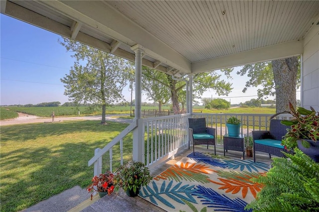 view of patio with a porch and a rural view