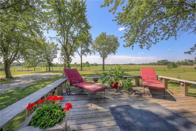 wooden deck featuring a rural view and a yard