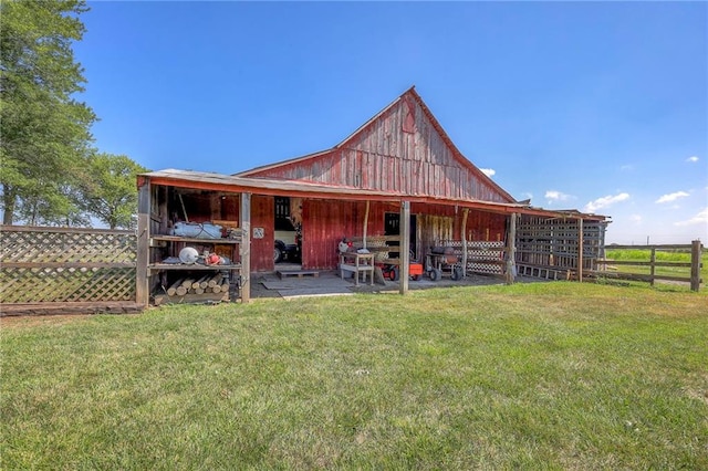 rear view of property featuring an outdoor structure