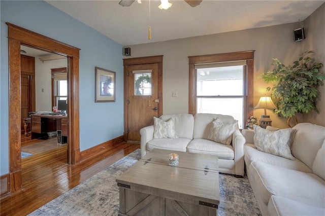 living room featuring hardwood / wood-style flooring, ceiling fan, and a healthy amount of sunlight