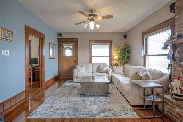 living room featuring a textured ceiling, plenty of natural light, and ceiling fan