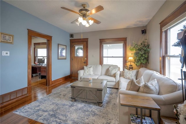 living room featuring light hardwood / wood-style flooring and ceiling fan