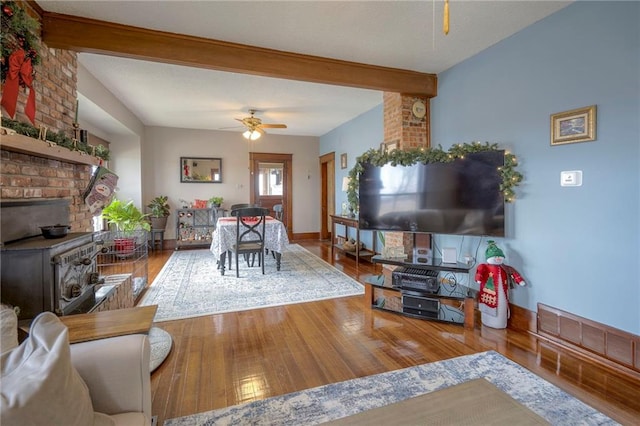 living room featuring hardwood / wood-style floors, ceiling fan, and beamed ceiling