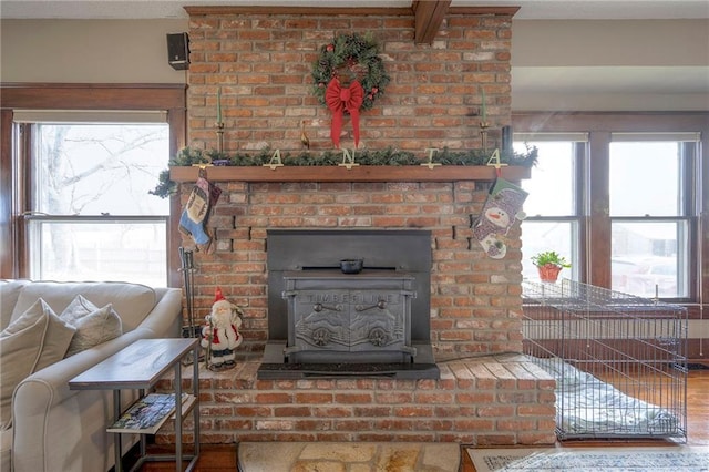 interior details with hardwood / wood-style flooring and a wood stove