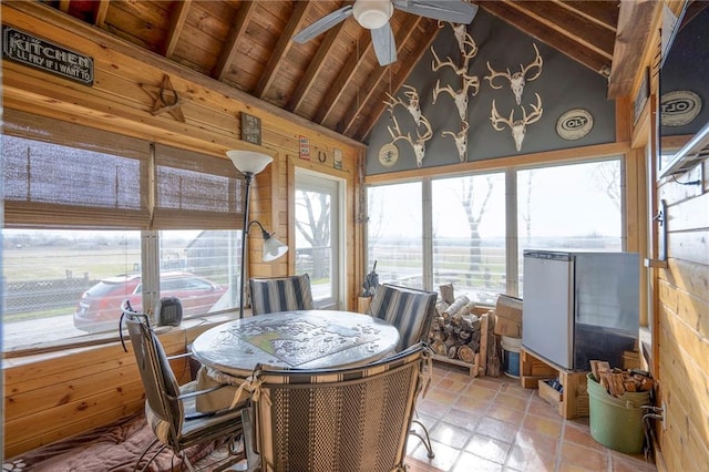 sunroom / solarium featuring vaulted ceiling with beams, ceiling fan, and wood ceiling