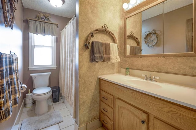 bathroom featuring tile patterned flooring, vanity, and toilet