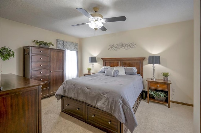 bedroom featuring ceiling fan and light carpet