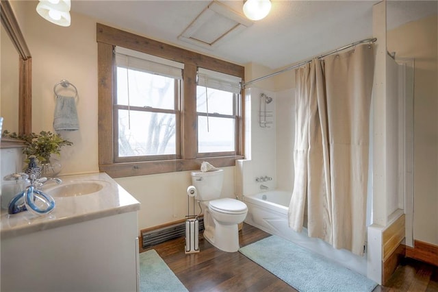 full bathroom featuring hardwood / wood-style floors, vanity, toilet, and shower / tub combo with curtain