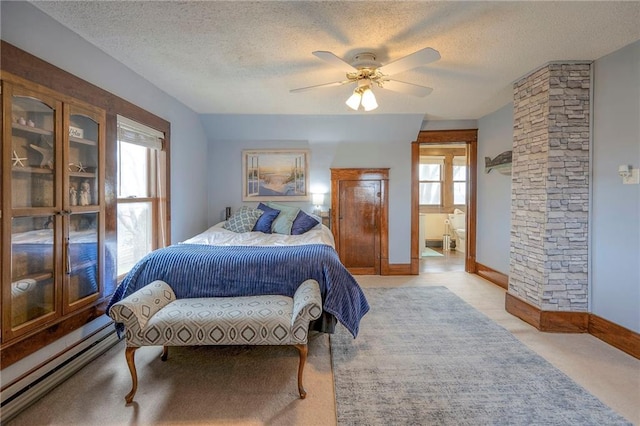 bedroom featuring multiple windows, a textured ceiling, ceiling fan, and a baseboard heating unit