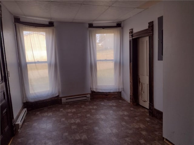 533 4th St, Barnard, MO 64423 - unfurnished room featuring a baseboard radiator, healthy amount of natural light, and a paneled ceiling