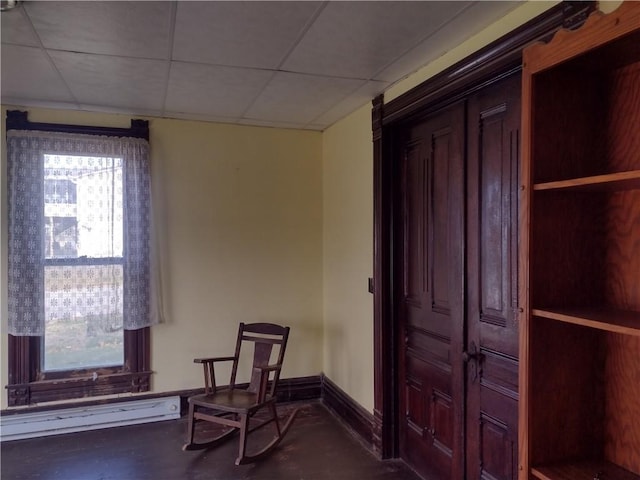 533 4th St, Barnard, MO 64423 - unfurnished room featuring a baseboard heating unit and a paneled ceiling
