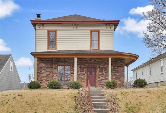 italianate-style house with a front yard and covered porch