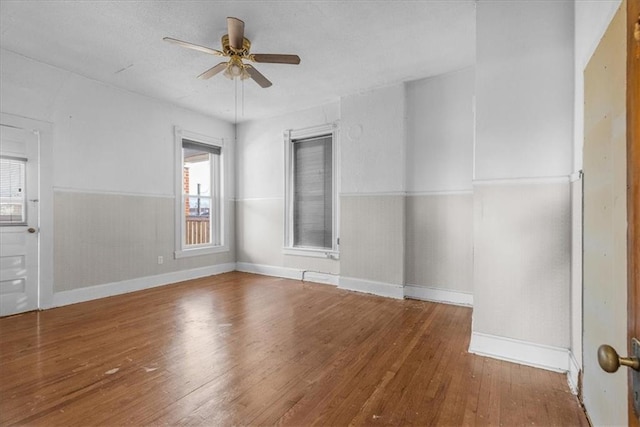 unfurnished room with wood-type flooring and ceiling fan