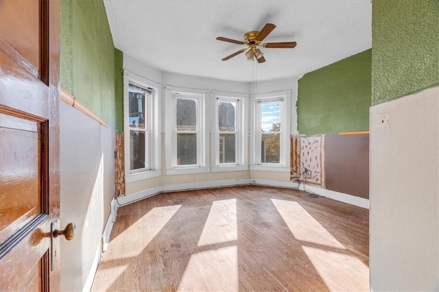 interior space with ceiling fan and light hardwood / wood-style flooring