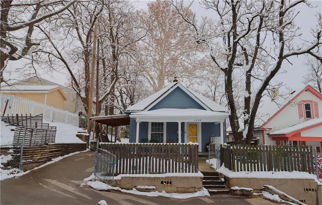 bungalow-style house with a porch and a carport