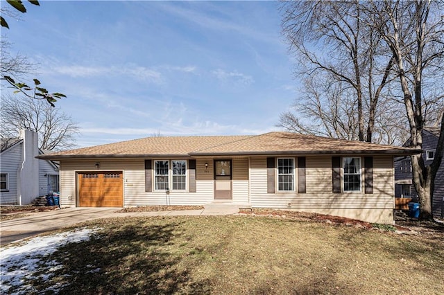 ranch-style home featuring driveway, an attached garage, and a front yard