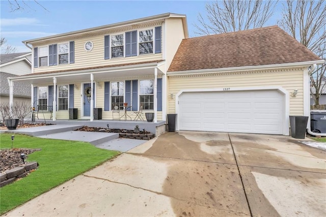 view of front of property with a garage and covered porch