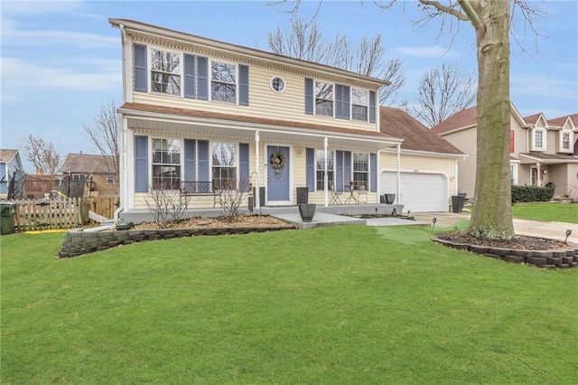 colonial inspired home featuring a garage, covered porch, and a front yard