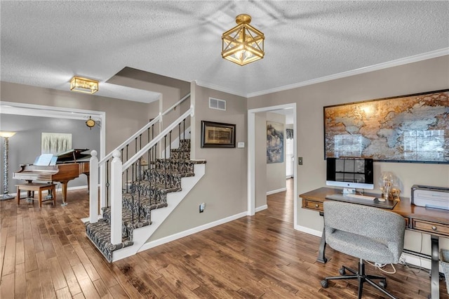 office with hardwood / wood-style flooring, ornamental molding, and a textured ceiling