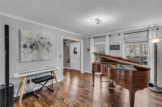 miscellaneous room featuring wood-type flooring, ornamental molding, and a textured ceiling