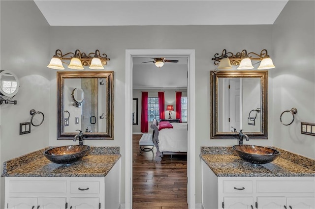 bathroom with vanity, hardwood / wood-style floors, and ceiling fan