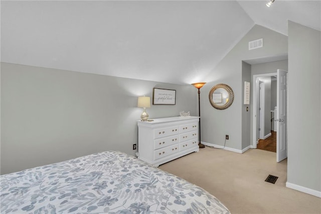 carpeted bedroom with lofted ceiling