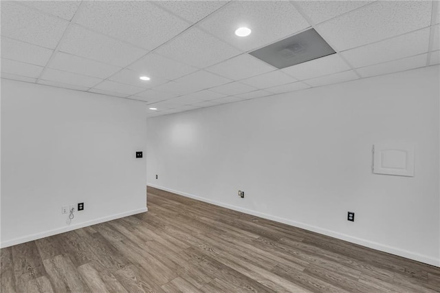 basement featuring hardwood / wood-style floors and a paneled ceiling