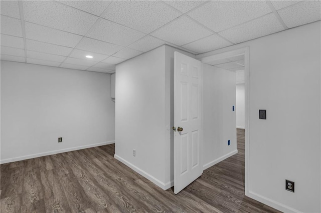 interior space featuring a drop ceiling and dark wood-type flooring