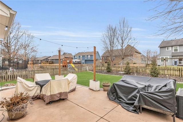 view of patio with a playground, a grill, and a trampoline