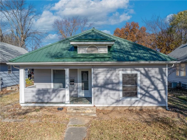 bungalow-style house featuring covered porch and central AC