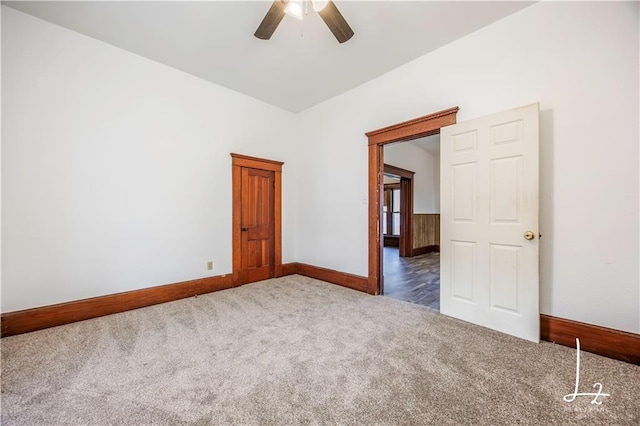 carpeted spare room with ceiling fan