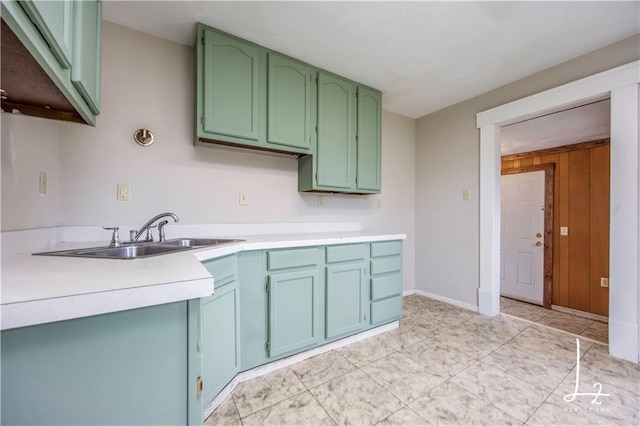 kitchen featuring green cabinets and sink