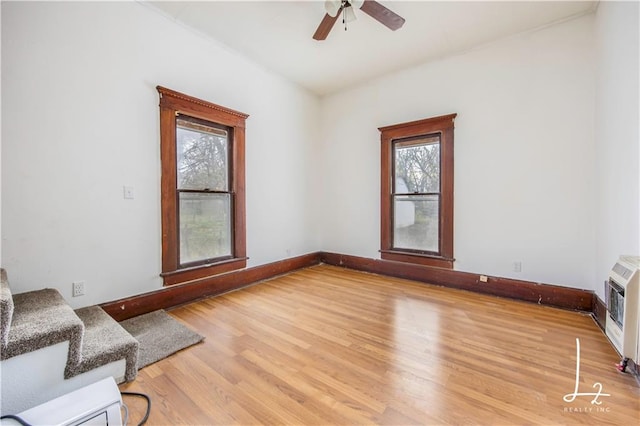 living area with ceiling fan and light wood-type flooring