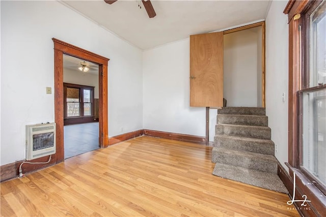 empty room featuring light wood-type flooring and heating unit