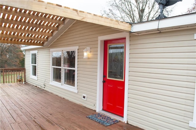 doorway to property with a pergola and a deck