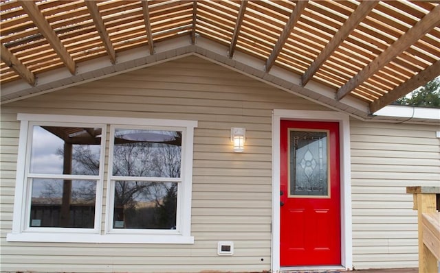 property entrance with a pergola