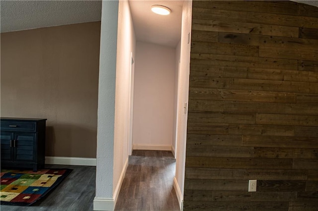 hall featuring dark hardwood / wood-style flooring and a textured ceiling