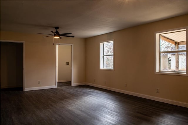 spare room with ceiling fan and dark hardwood / wood-style flooring